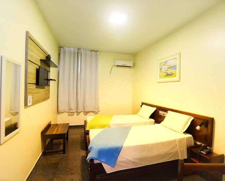 Postel nebo postele na pokoji v ubytování Hotel Monte Pascoal