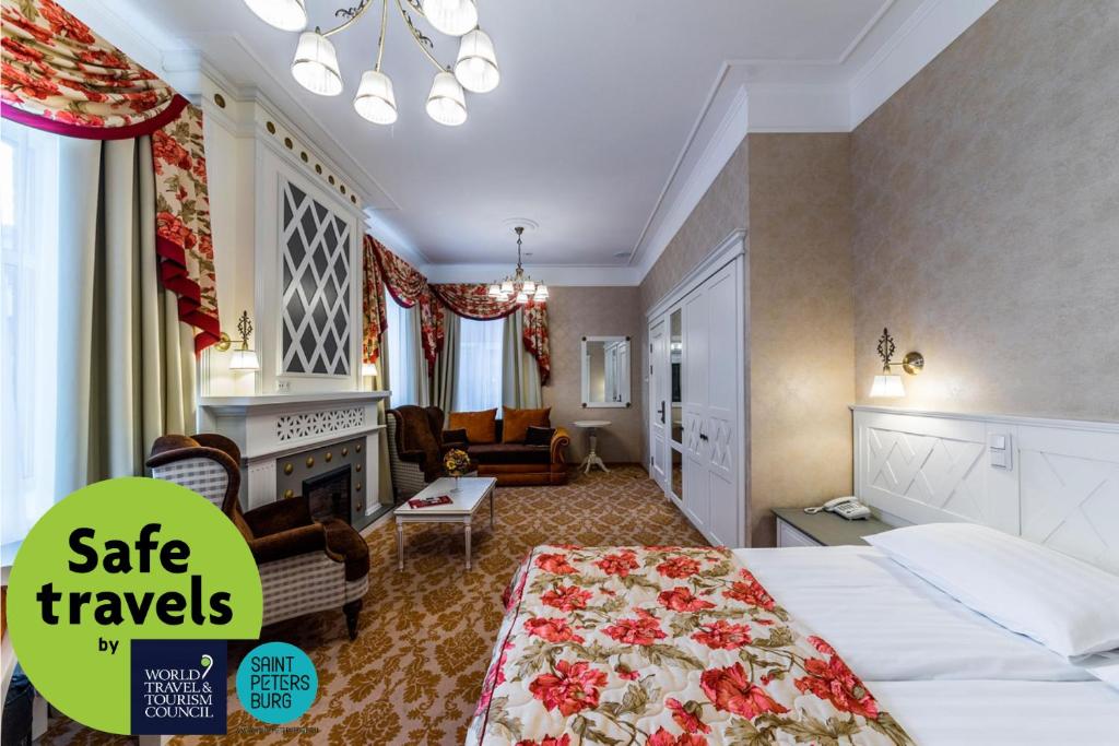 a hotel room with a bed and a living room at Cronwell Inn Stremyannaya in Saint Petersburg