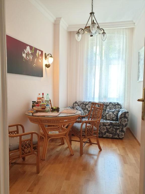 a living room with a table and a couch at Jurincom apartments Masaryka in Karlovy Vary