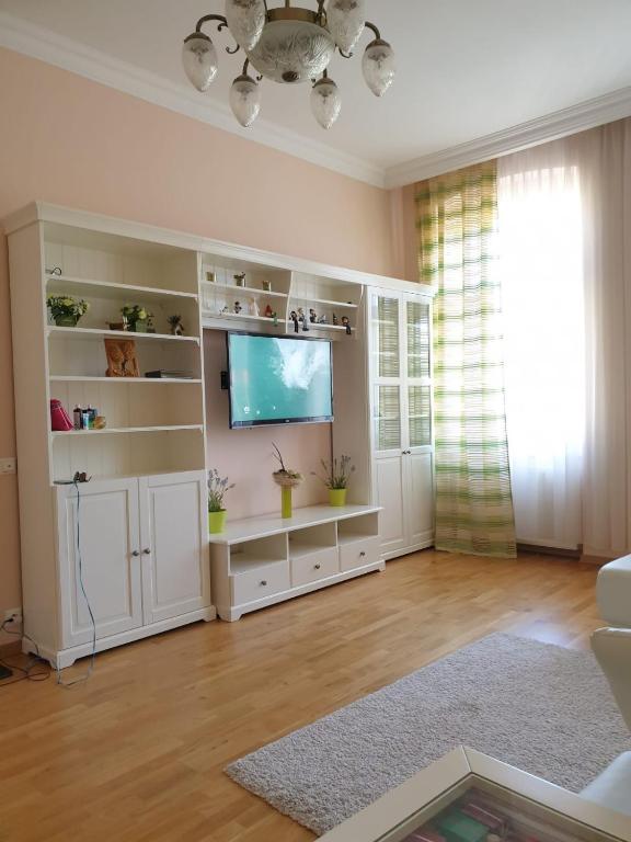 a living room with a large white entertainment center at Jurincom apartments Masaryka in Karlovy Vary