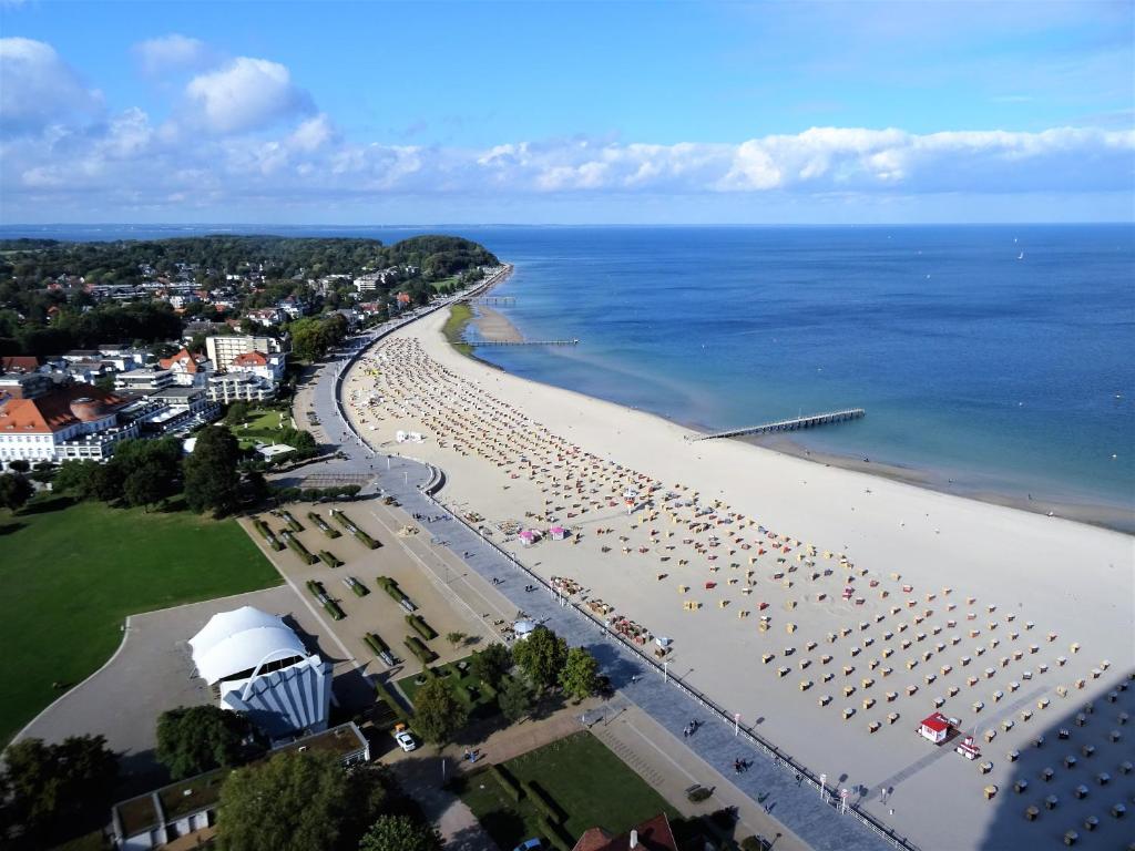 an aerial view of a beach with chairs and umbrellas at Apartments Villa Seeblick Travemünde in Travemünde