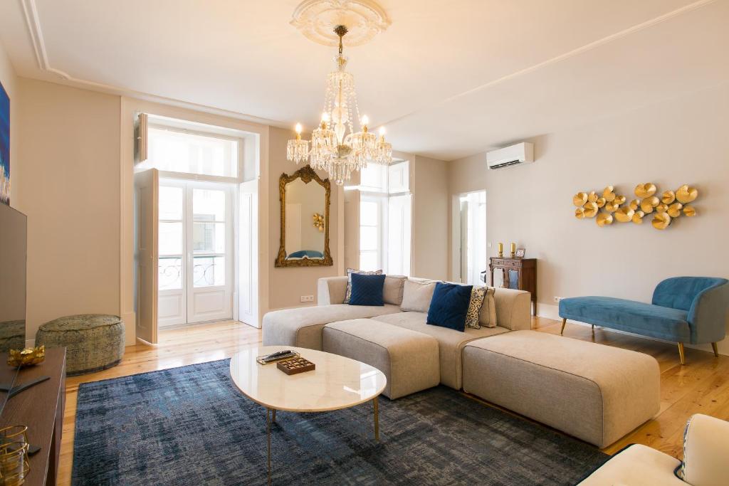 a living room with a couch and a table at Chiado Deluxe Gem 4bdr Amazing apartment in Lisbon