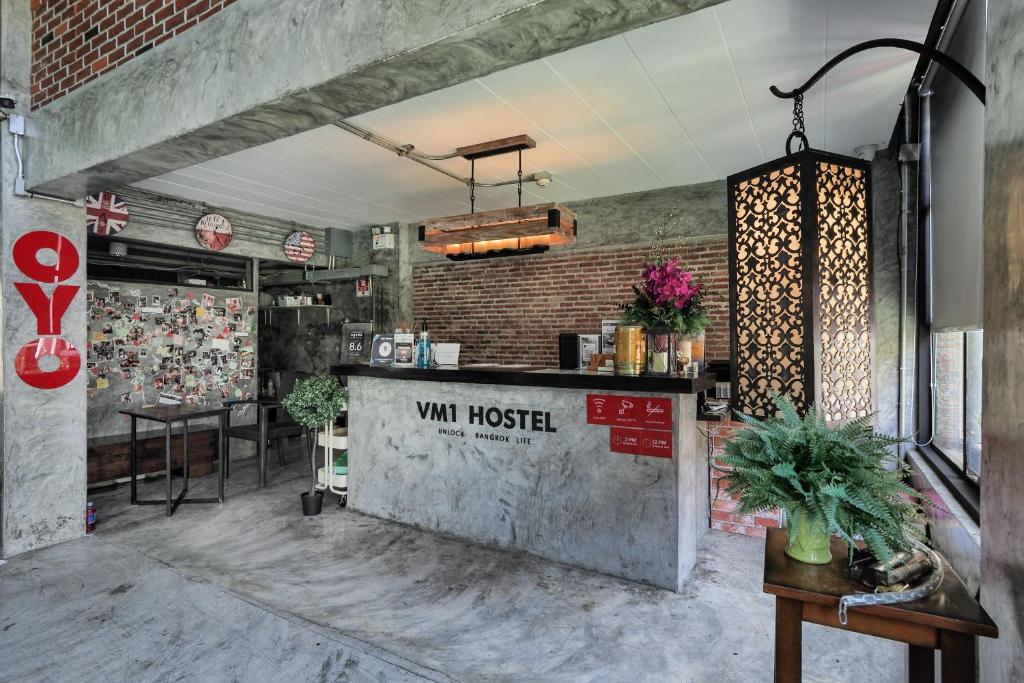 a restaurant with a counter in a room at Super OYO 75332 Vm1 Hostel in Bangkok