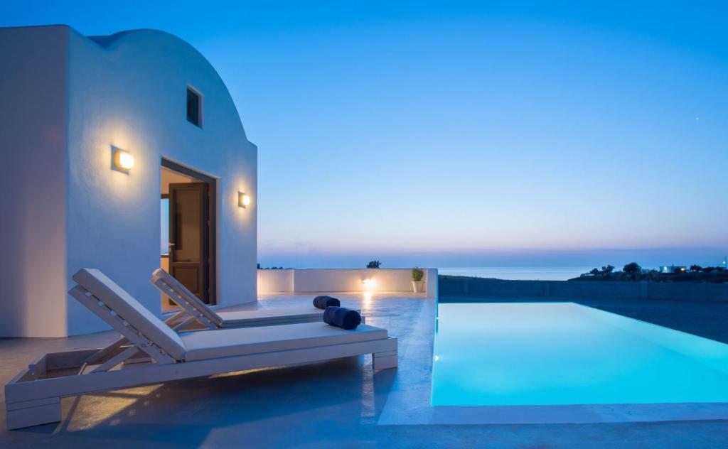 a villa with a swimming pool at night at Luxury Santorini Villa Villa Luxury Private Pool Sea View Imerovigli in Foinikiá