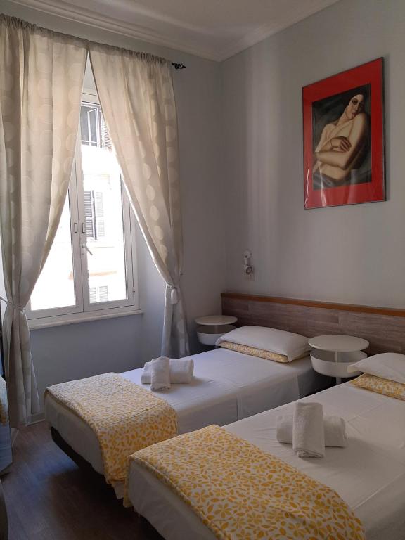 Postel nebo postele na pokoji v ubytování Hotel Castelfidardo