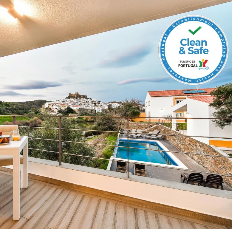 a view from the balcony of a villa with a swimming pool at Quinta do Vau in Mértola