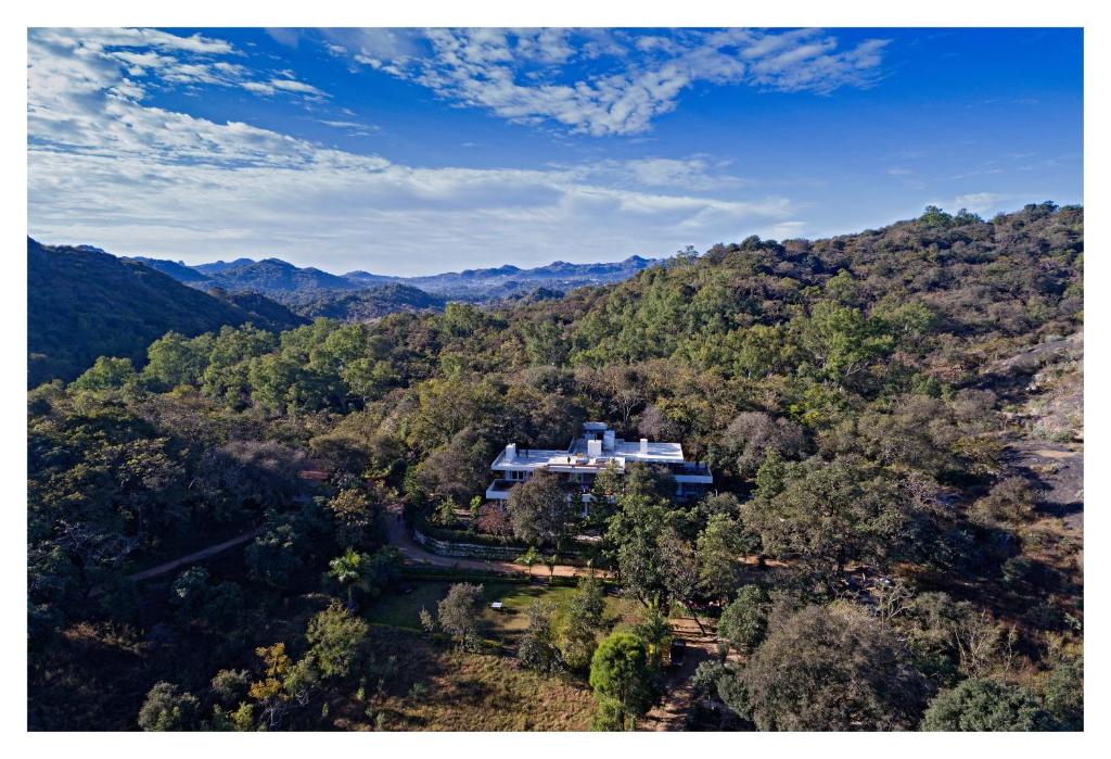 an aerial view of a house in the middle of a forest at Wordsworth Lodge in Mount Ābu