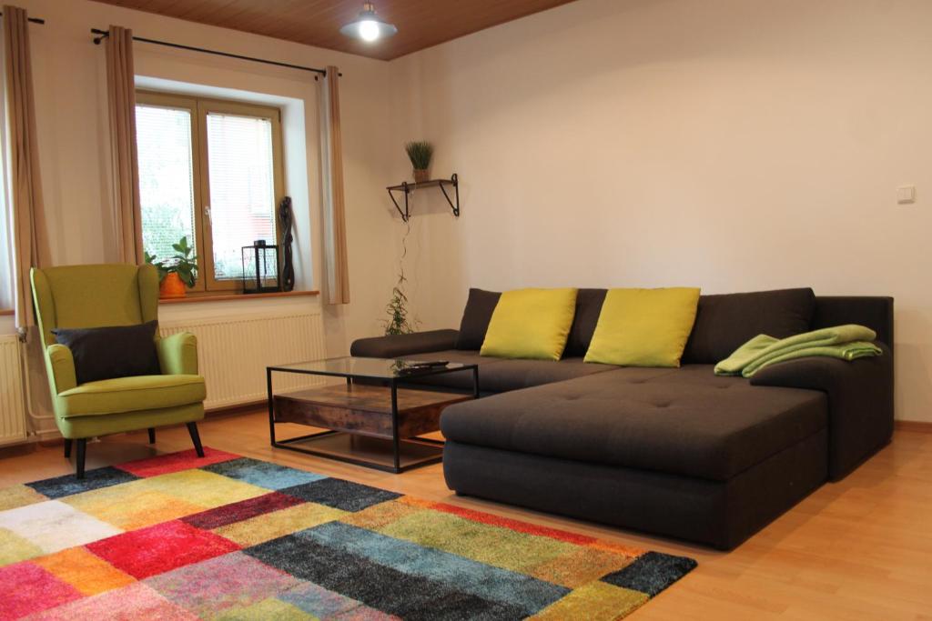 a living room with a couch and a chair at Apartmán Domčeková in Košice