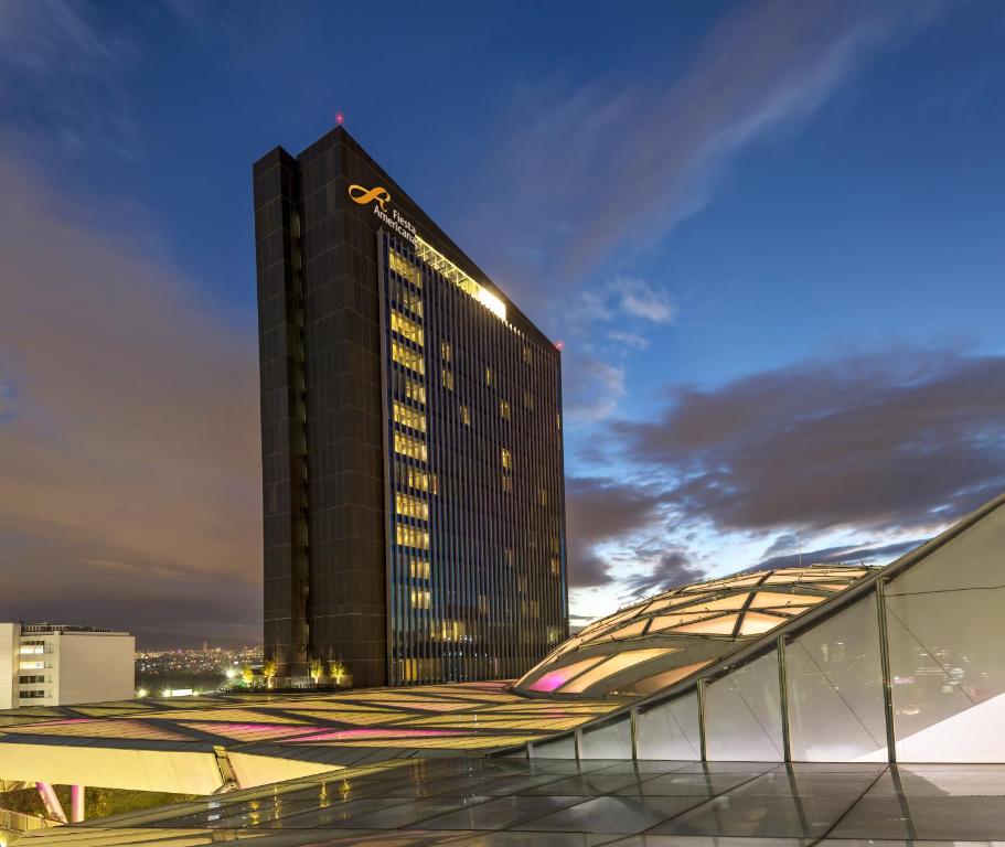 a tall black building with yellow lights on it at Fiesta Americana Mexico Toreo in Mexico City
