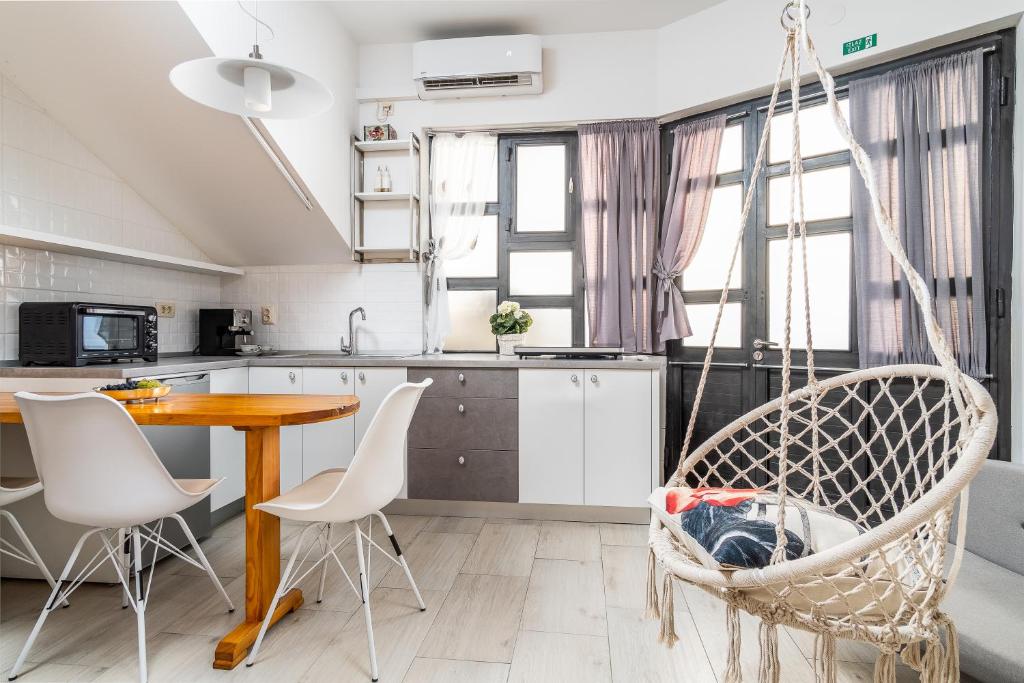 a kitchen with a table and chairs and a swing at Apartment Tomas in Split