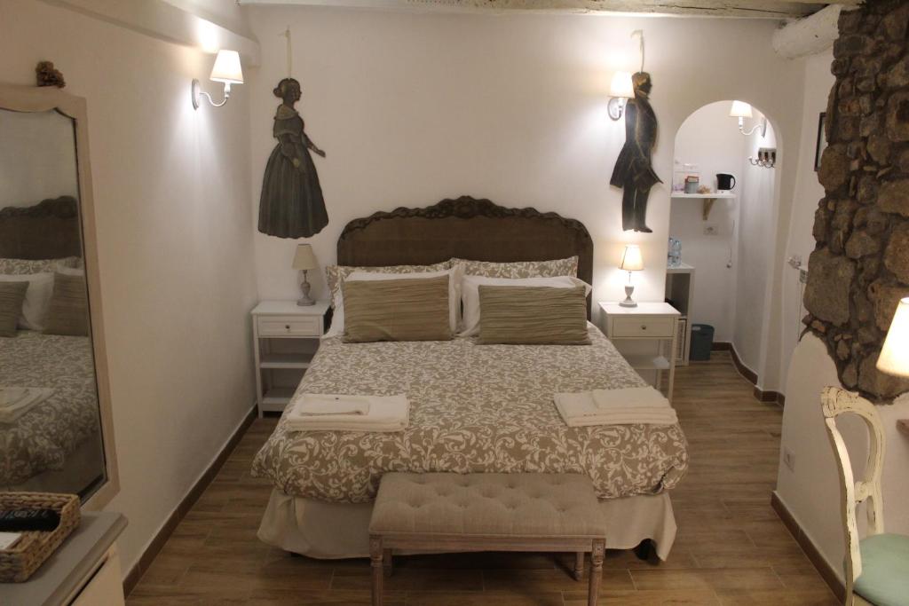 a bedroom with a large bed and two night stands at Livia's Charming Room in Trevignano Romano