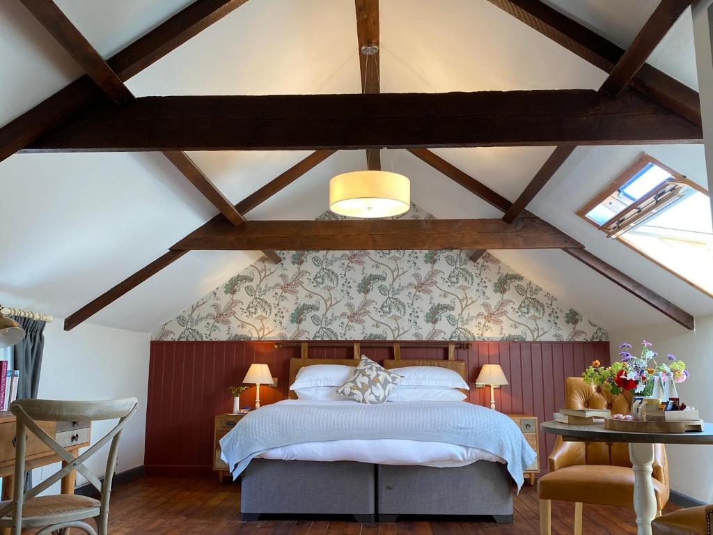 a bedroom with a large bed in a attic at The Countryman Inn in Wool