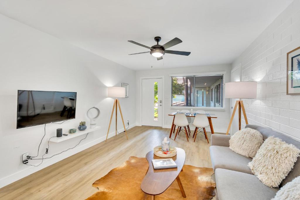 a living room with a couch and a tv at Modern Contemporary OT Scottsdale with Heated Pool in Scottsdale