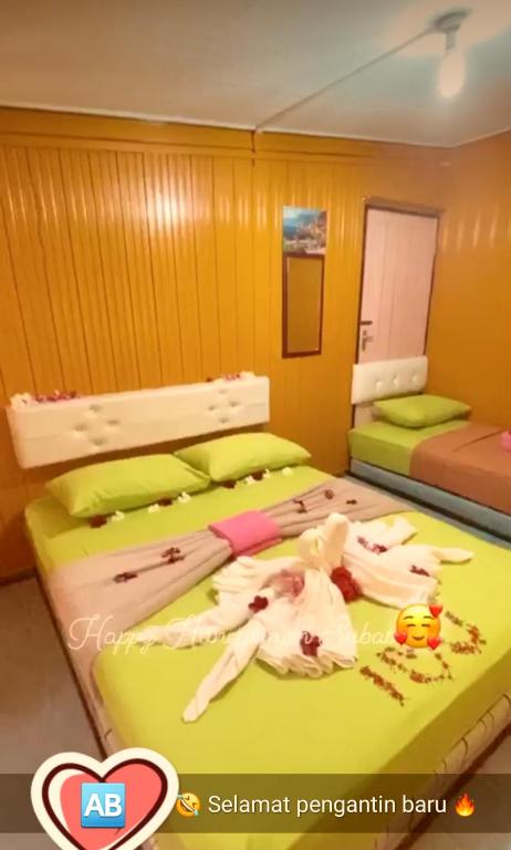 Postel nebo postele na pokoji v ubytování Perhentian AB Guest House