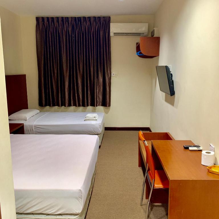 Postel nebo postele na pokoji v ubytování New Grand Hotel