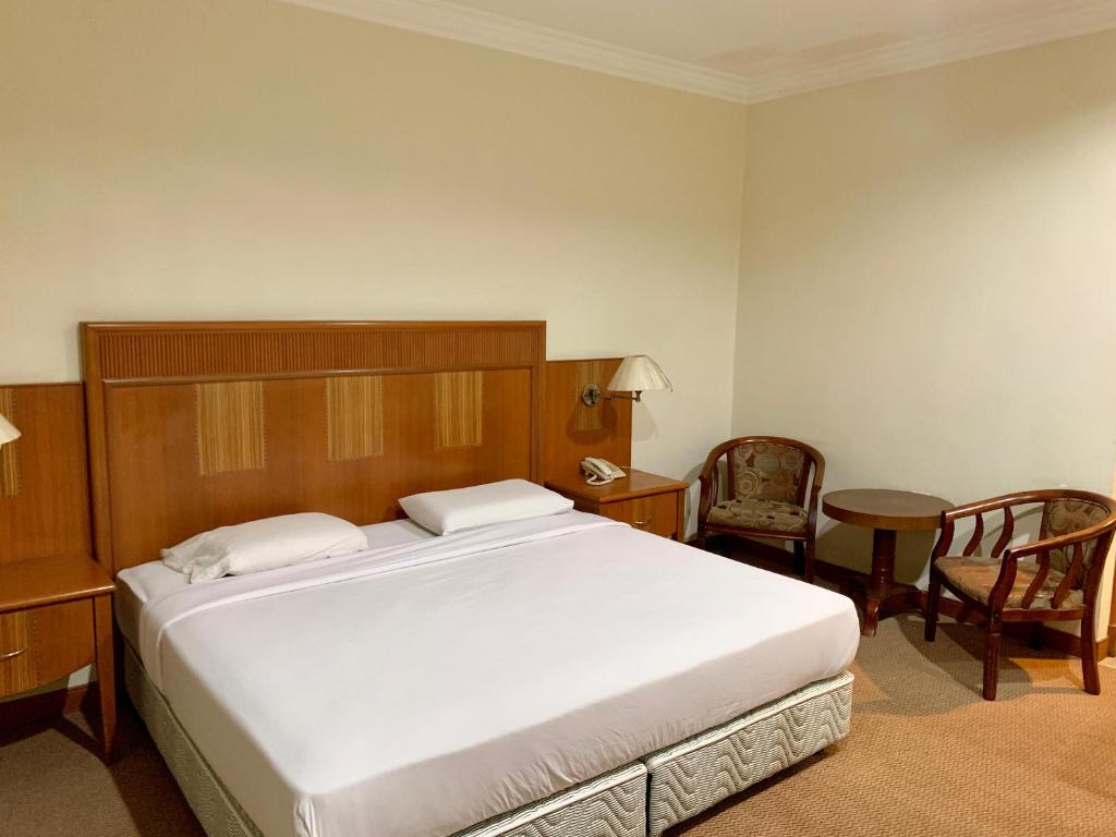 Postel nebo postele na pokoji v ubytování New Grand Hotel