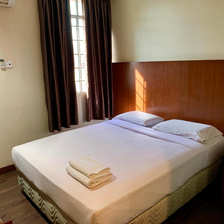 Postel nebo postele na pokoji v ubytování New Grand Hotel