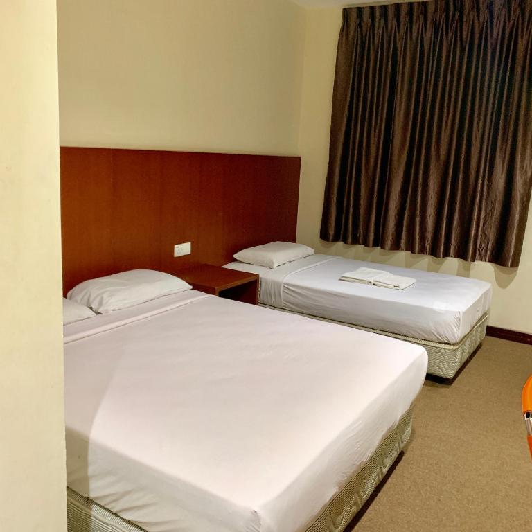 Postel nebo postele na pokoji v ubytování New Grand Hotel