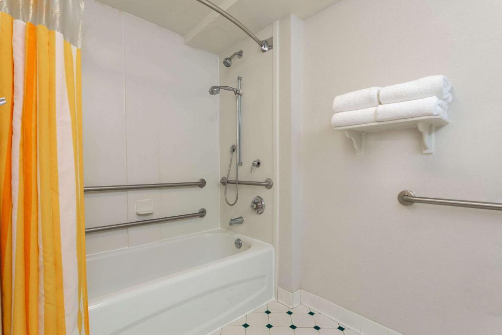 a bathroom with a shower and a bath tub at La Quinta by Wyndham Lakeland West in Lakeland