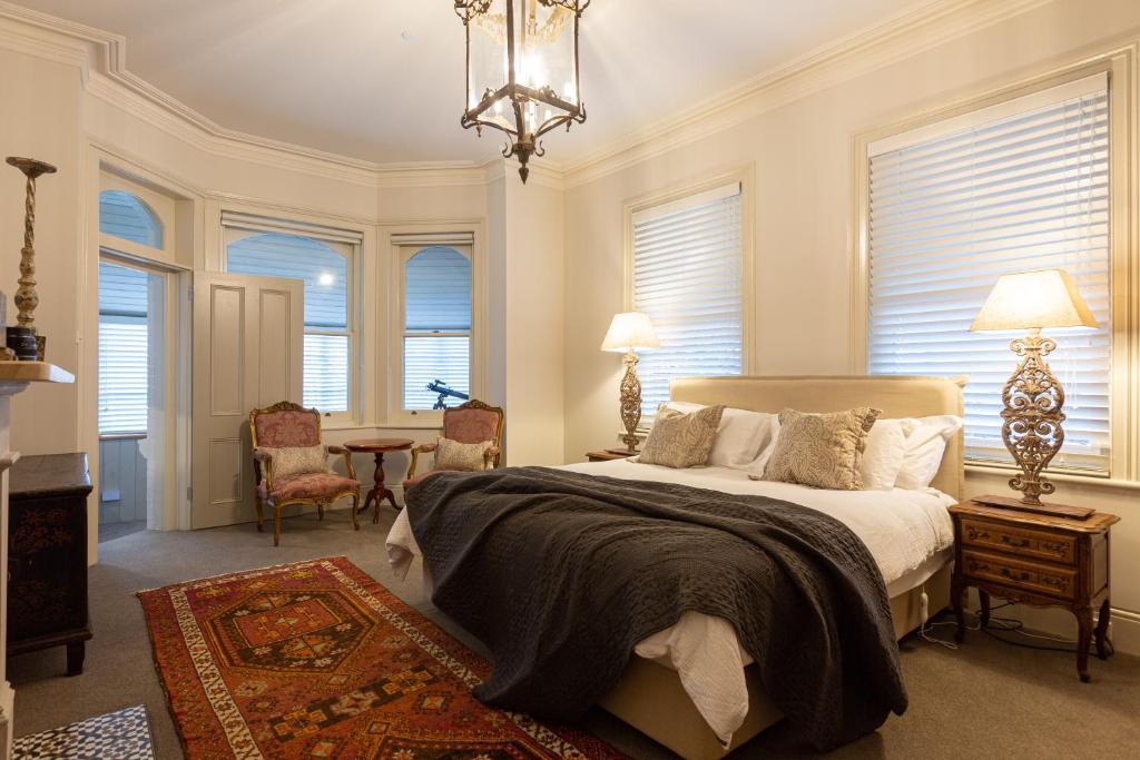 a bedroom with a bed and a table and chairs at The Rivulet in Hobart