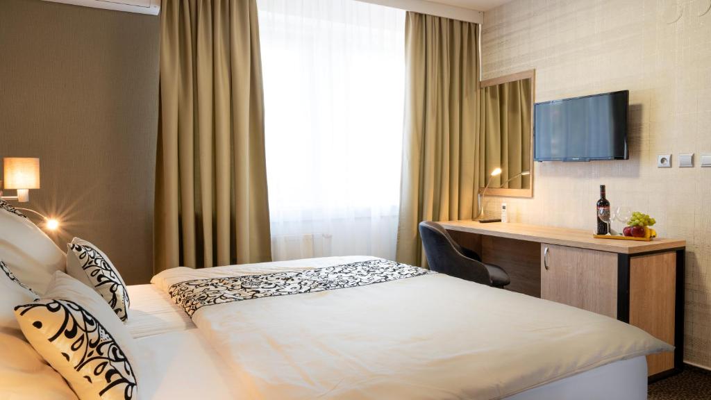 Postel nebo postele na pokoji v ubytování Hotel Karolina