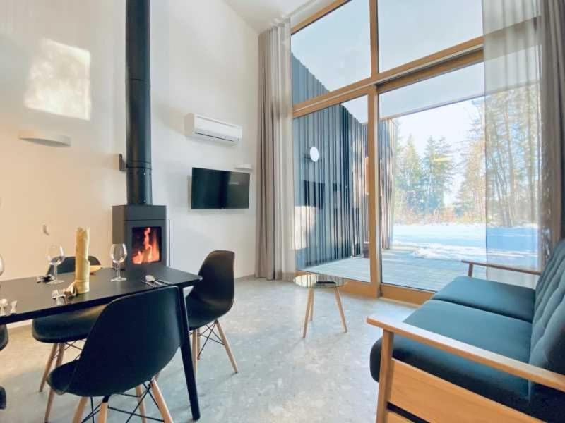 a living room with a blue couch and a fireplace at Apartments Cokla Zero in Zreče