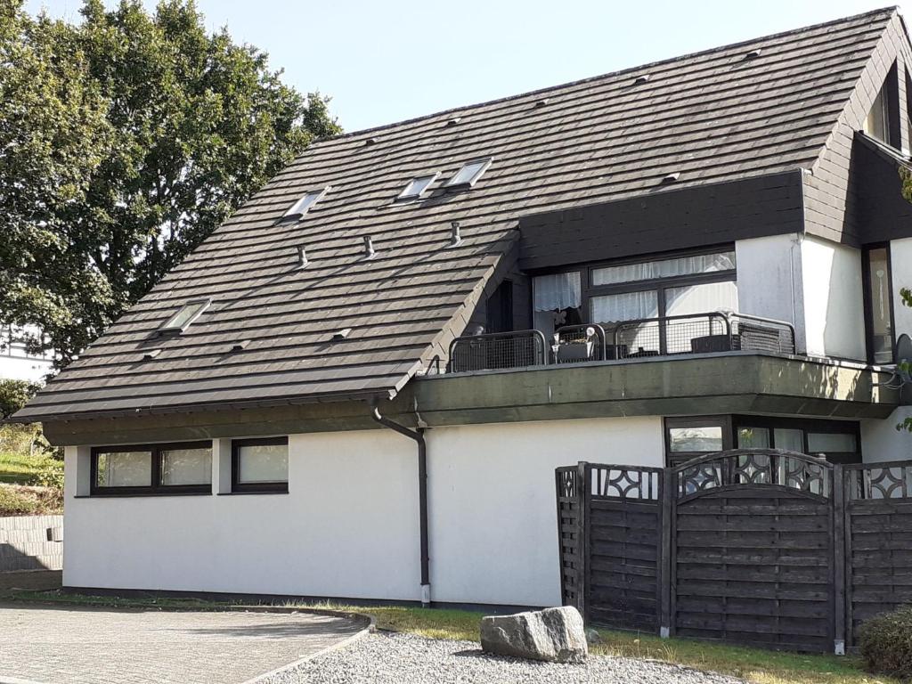 a white house with a black roof at Ferienwohnung JuLe in Winterberg