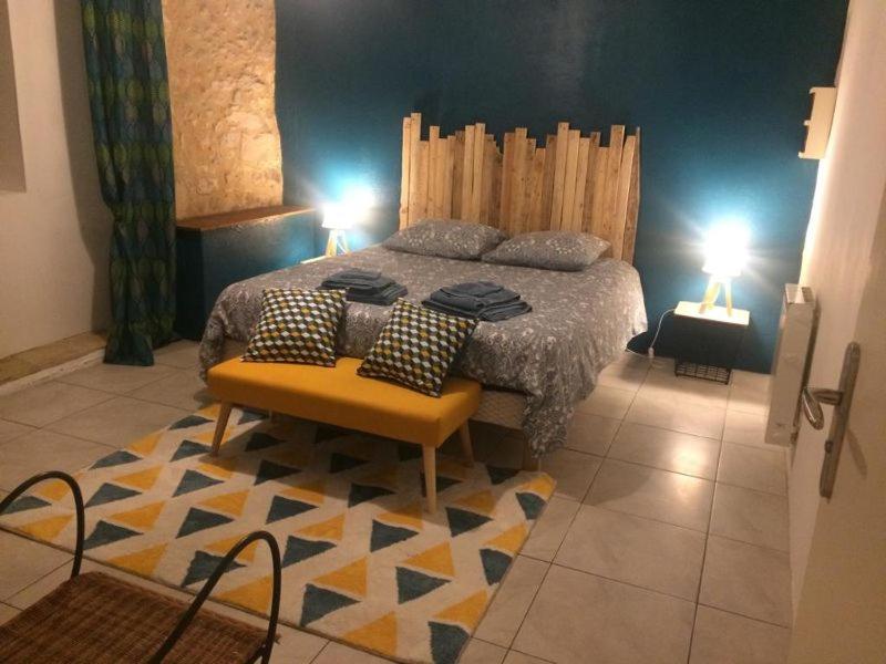 a bedroom with a bed with two lamps and a rug at Appartement 2 personnes Le Bugue Périgord Noir in Le Bugue