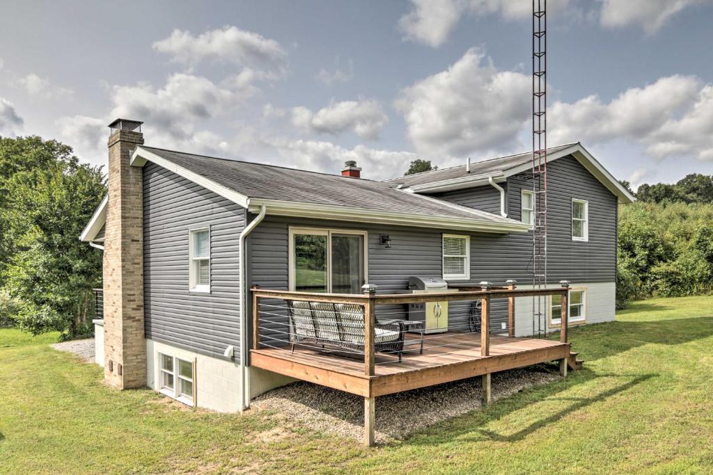 a house with a large deck in front of it at Modern Zanesville Escape with Deck and Spacious Yard in Zanesville