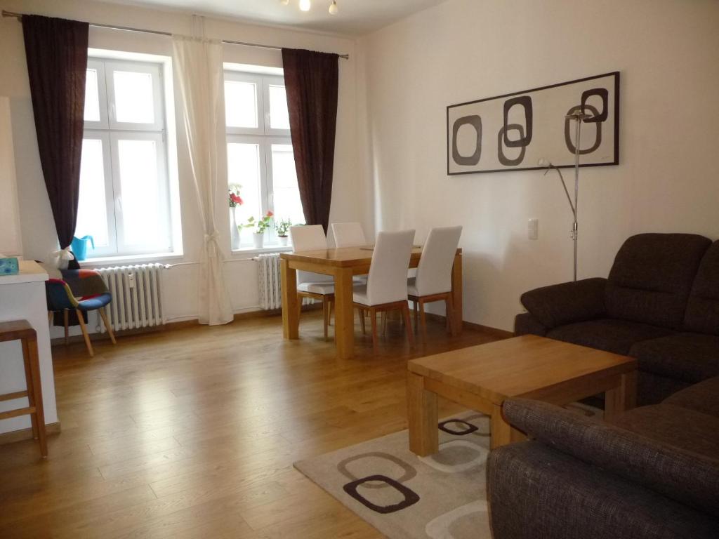 a living room with a table and a couch at Amazing City center apartment with balcony in Moravská Ostrava