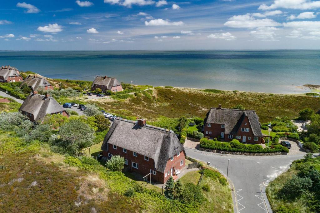 una vista aérea de una casa en una colina con el océano en Lenas Hüs en List