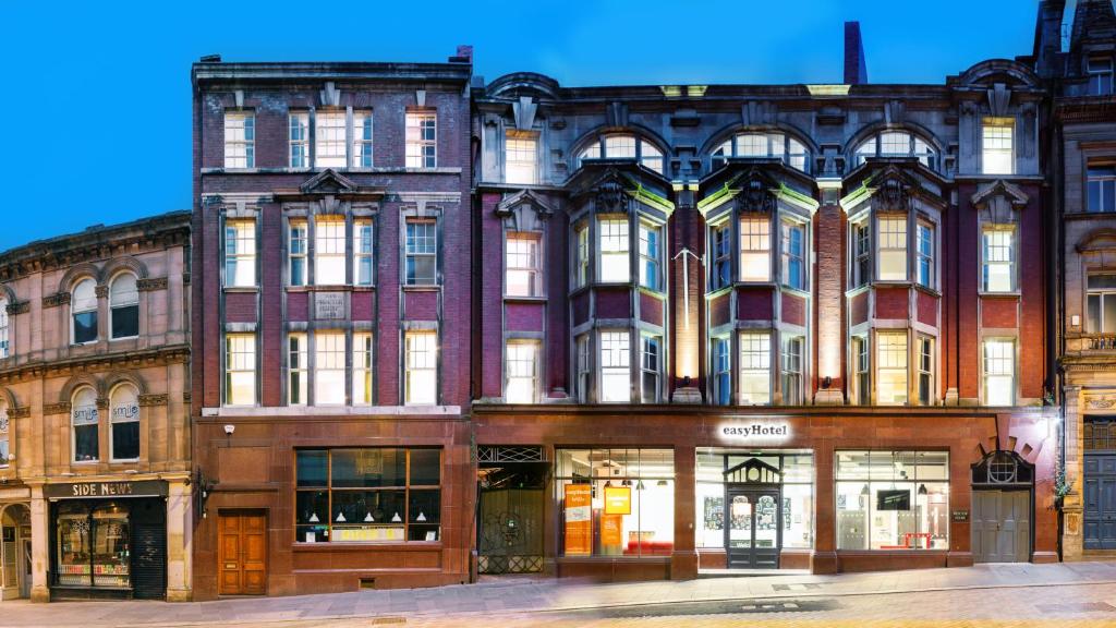 a large brick building on a city street at easyHotel Newcastle in Newcastle upon Tyne