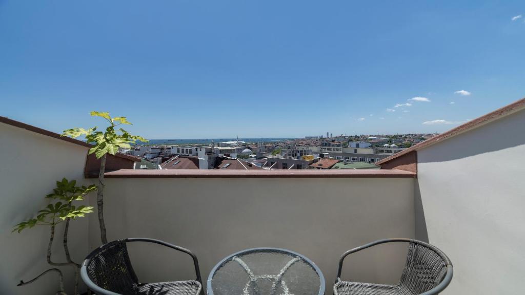 a balcony with two chairs and a view of a city at Holiday Inn Istanbul Old City by IHG in Istanbul