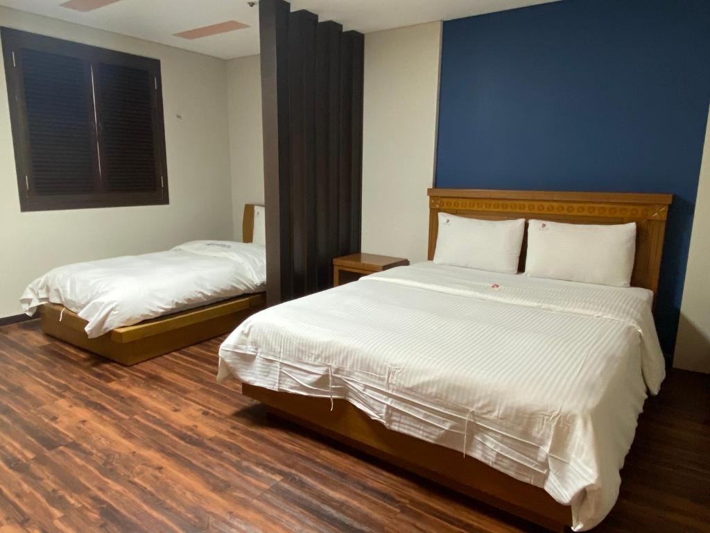 Postel nebo postele na pokoji v ubytování Benikea Daelim Hotel