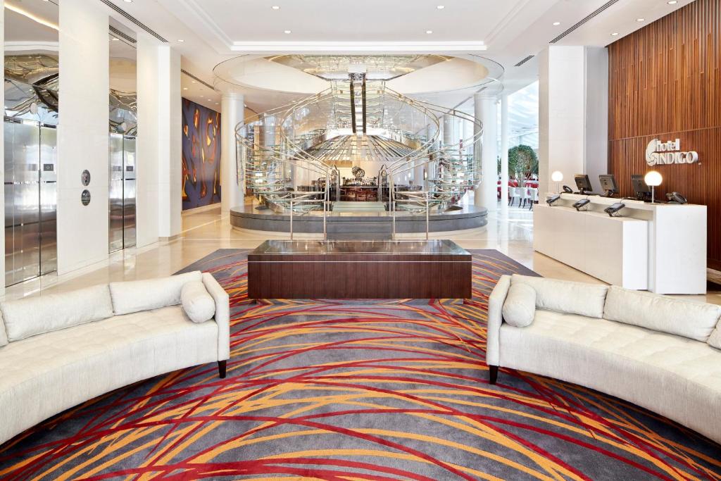 a lobby with two white couches and a large rug at Hotel Indigo Atlanta Downtown, an IHG Hotel in Atlanta