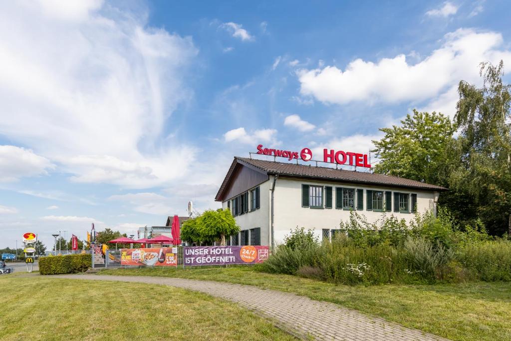 a hotel with a sign on top of a building at Serways Hotel Rhynern-Süd in Hamm