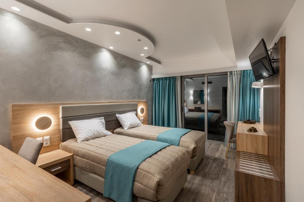 Posteľ alebo postele v izbe v ubytovaní Xenophon Hotel