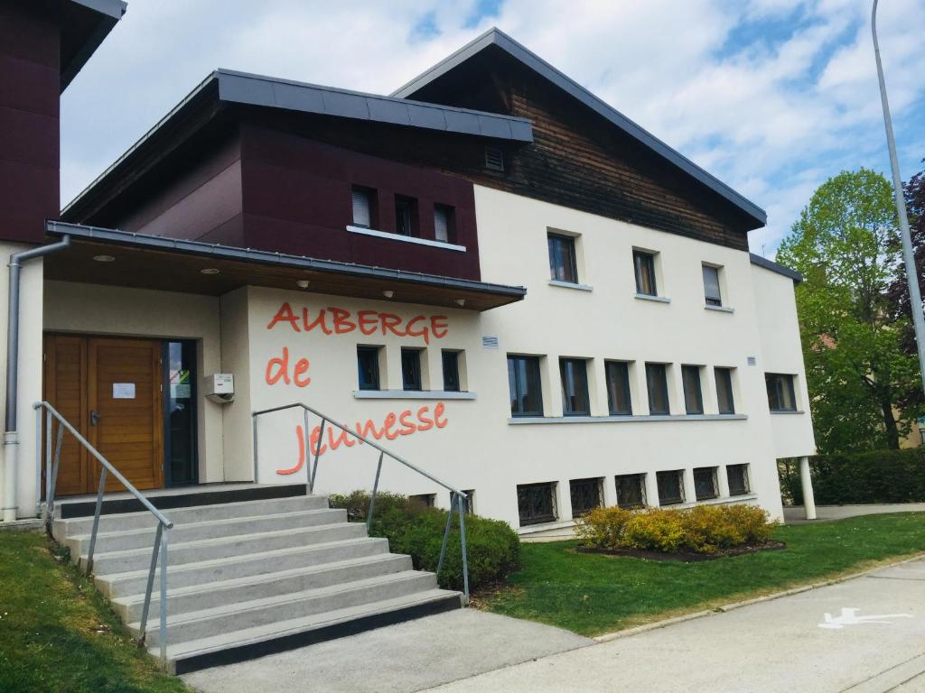 a white building with graffiti on the side of it at Auberge de Jeunesse HI Pontarlier in Pontarlier