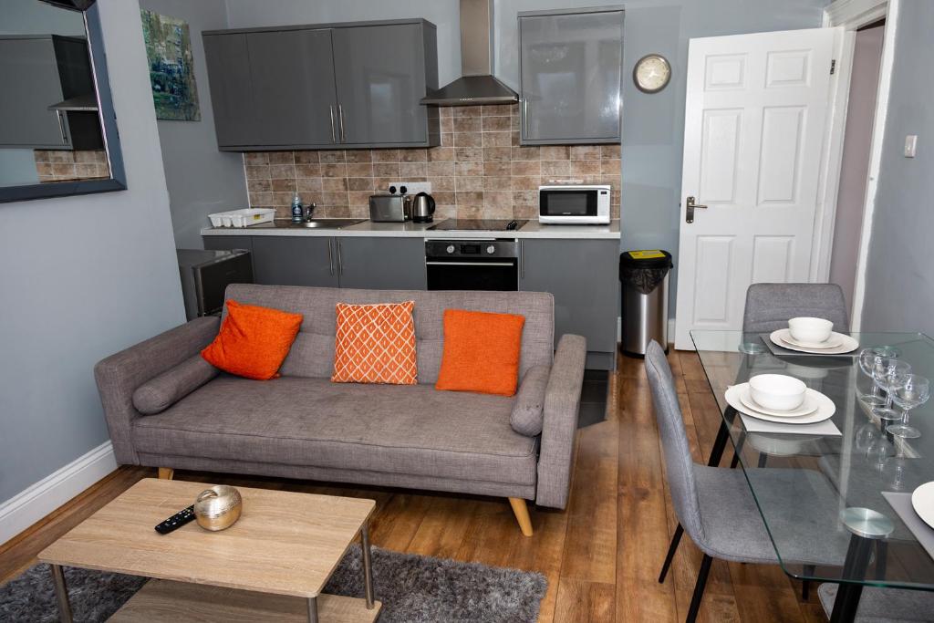 a living room with a couch and a table at Tyne Apartments in Gateshead