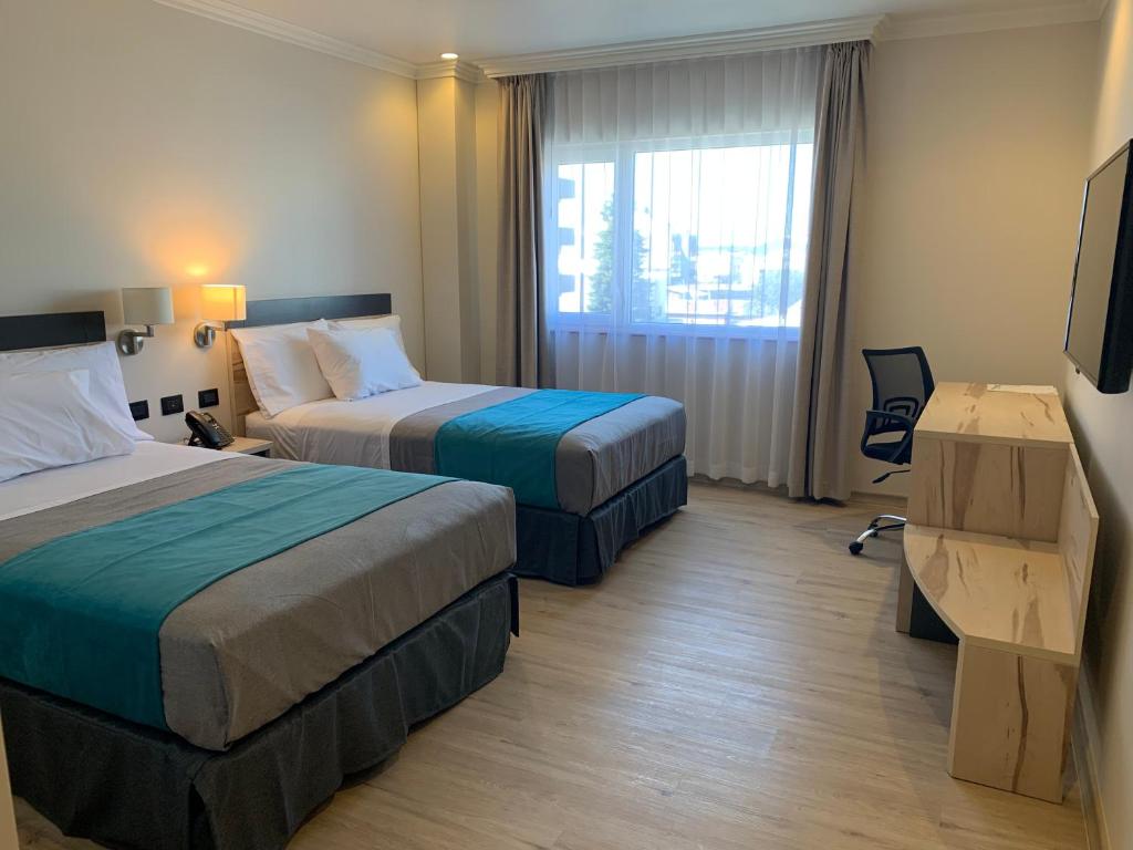 Una cama o camas en una habitación de Hotel Diego de Almagro Temuco Express