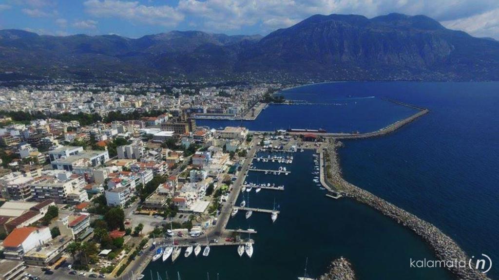 an aerial view of a city with a harbor and water at Anastasia apartment in Kalamata