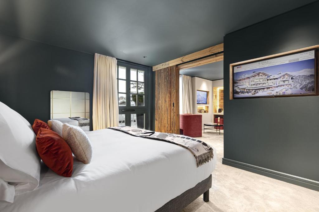 a bedroom with a large white bed in a room at Hotel Le Chabichou in Courchevel