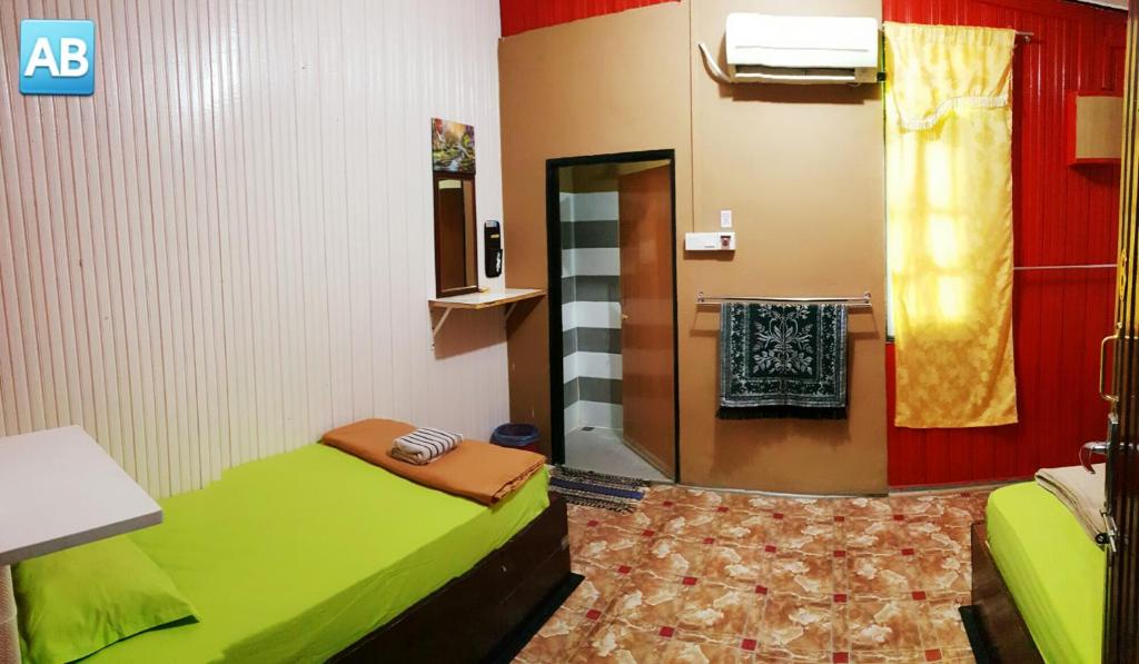 Postel nebo postele na pokoji v ubytování Perhentian AB Guest House