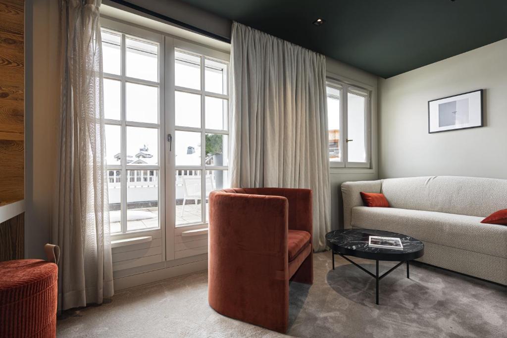 a living room with a couch and a chair at Hotel Le Chabichou in Courchevel