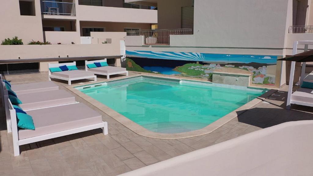 a swimming pool with lounge chairs and a swimming pool at La Contessa in Santa Teresa Gallura