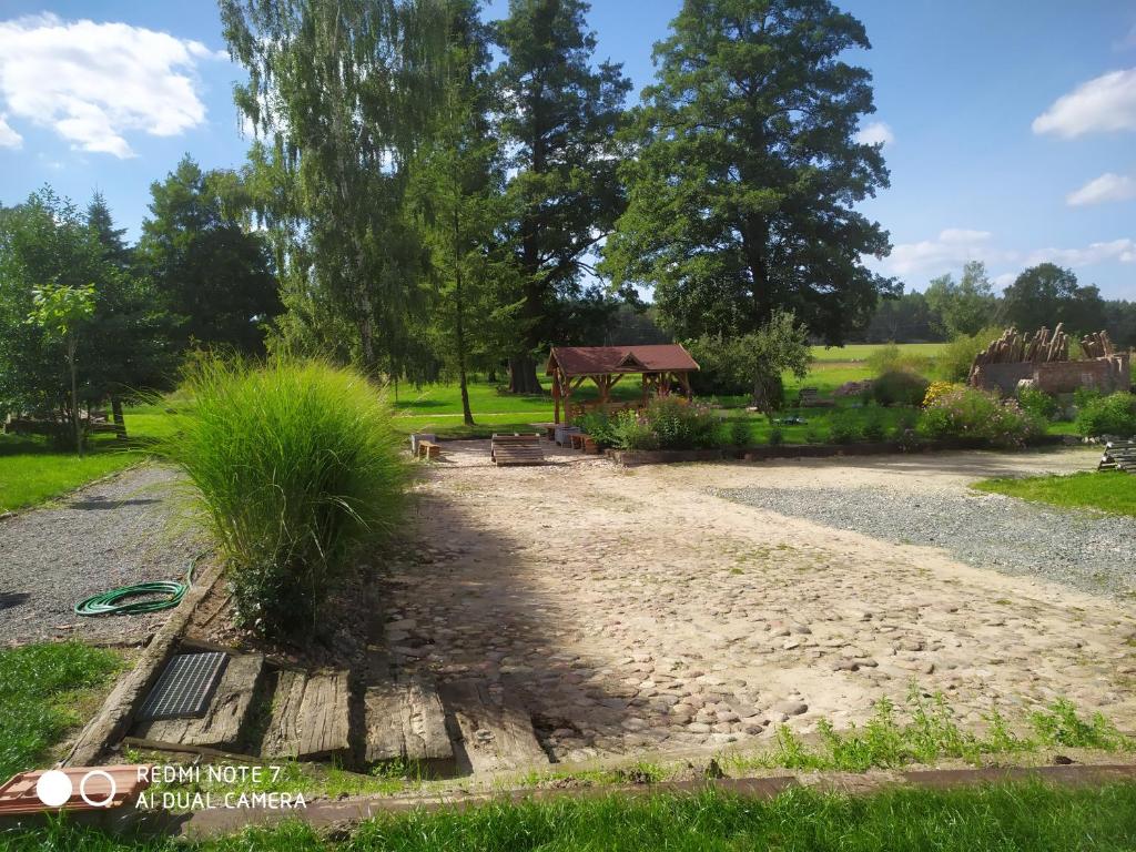a gravel path with a gazebo in a park at Agroturystyka "U Źródła" in Milicz