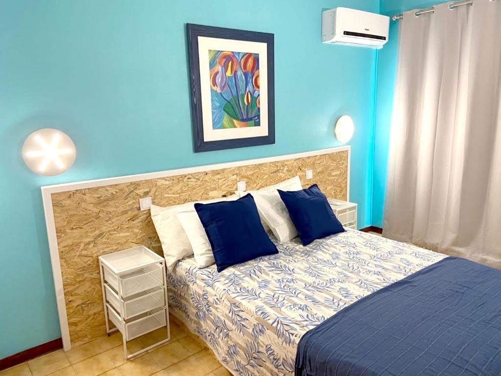 a blue bedroom with a bed with blue walls at Charming apartment with balcony in Portimão, 55 sqm, pool view in Portimão