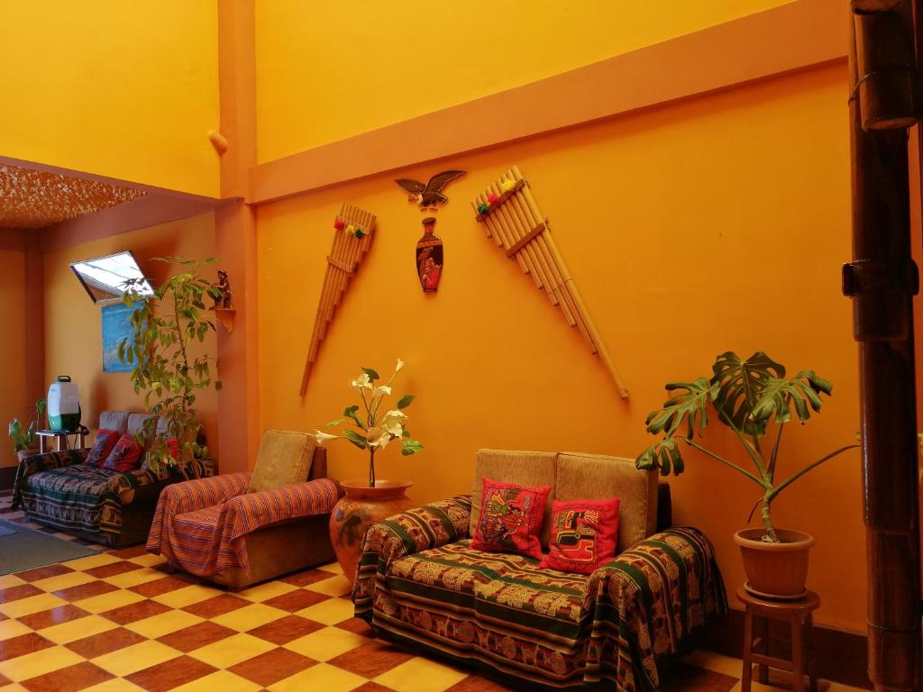 sala de estar con 2 sofás y suelo a cuadros en Hostal Olas Del Titicaca en Copacabana