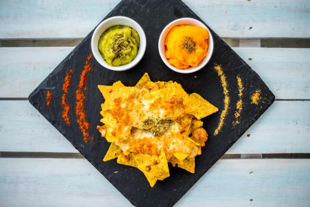 a black board with food on it with two bowls of food at Camelina Suites in San Antonio Bay