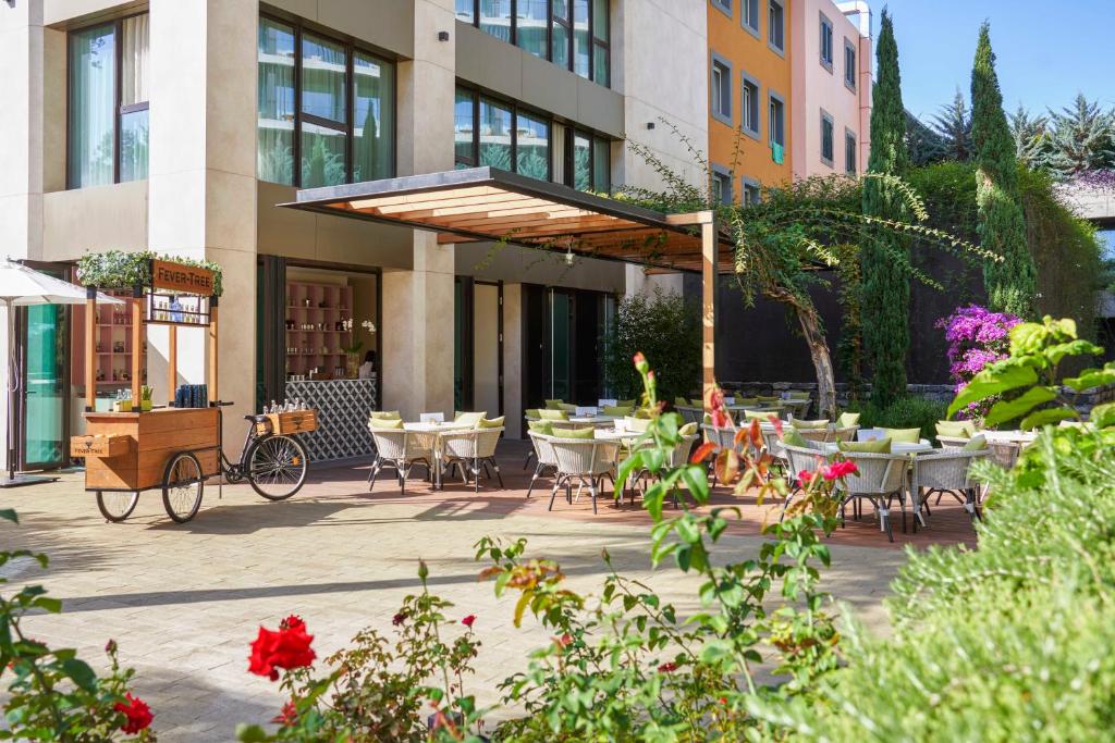 a patio with tables and chairs in front of a building at Savoy Palace - The Leading Hotels of the World - Savoy Signature in Funchal